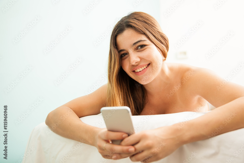 Pretty girl using a phone at the spa Pretty girl using a phone at the spa