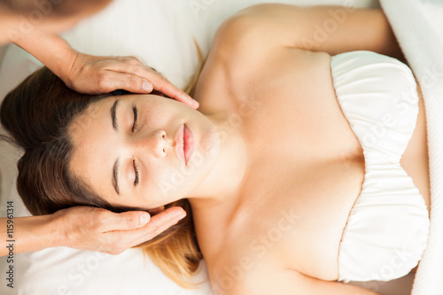 Woman receiving reiki therapy at a spa