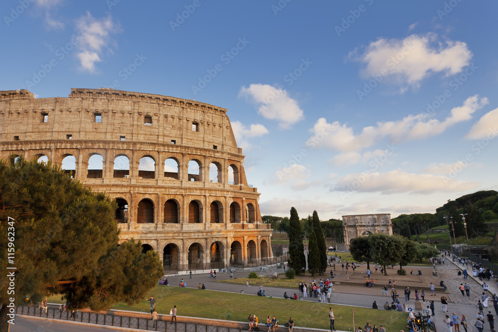 People visiting the Colosseum and Constantine's Arch in Rome, Italy 