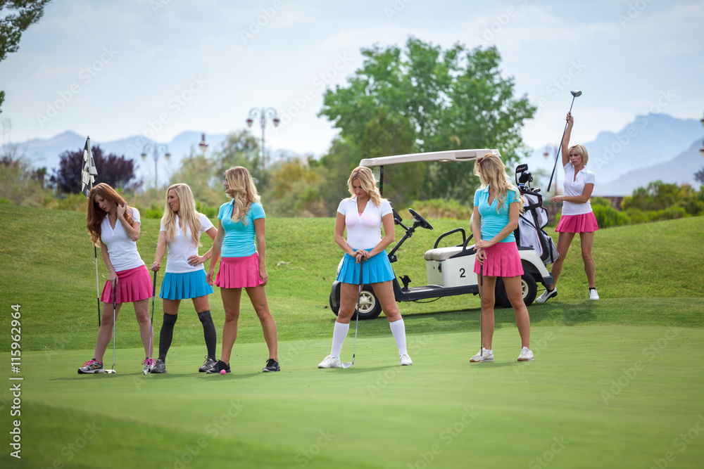Group of young female golf caddies on golf course. Group of young female golf caddies on golf course.