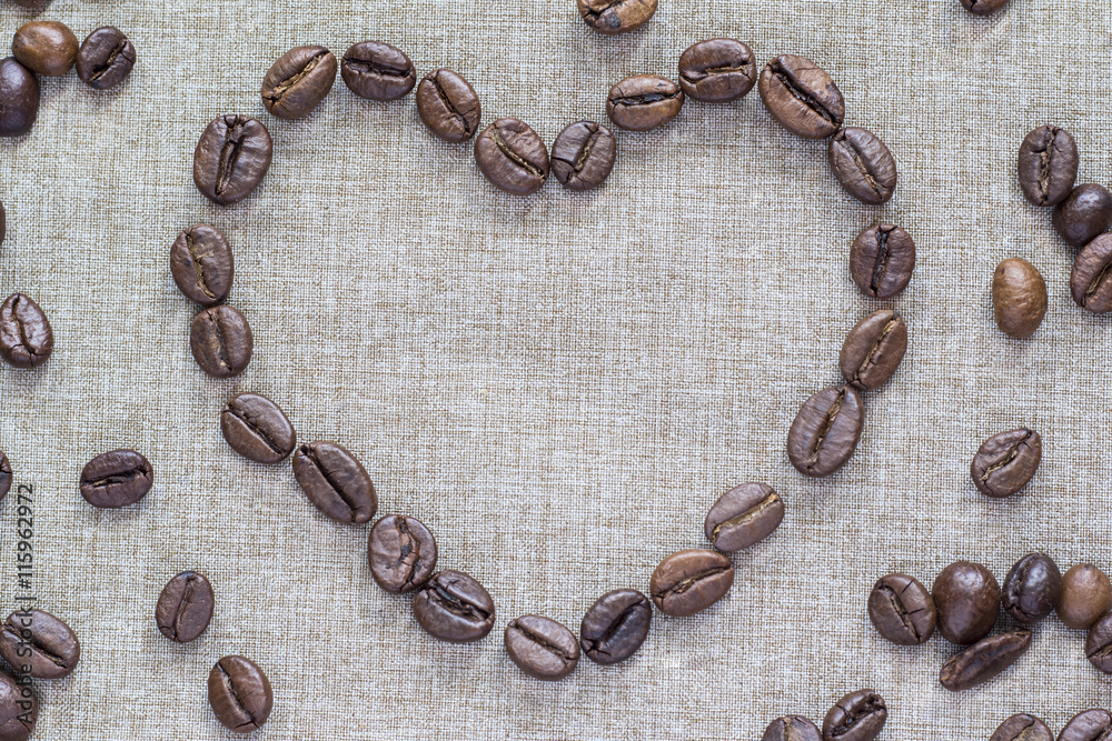 Heart of coffee beans on a linen background Heart of coffee beans on a linen background