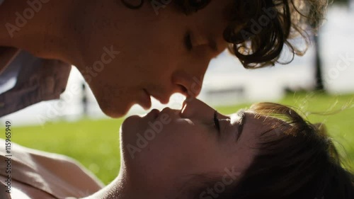 4K Young attractive couple share a kiss in the sunlight, in slow motion photo