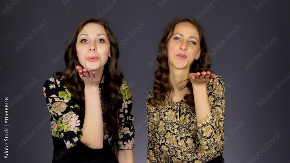 Two beautiful girls send an air kiss Two beautiful girls send an air kiss