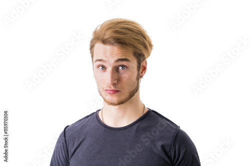 Sad or worried handsome young man looking down, isolated on white