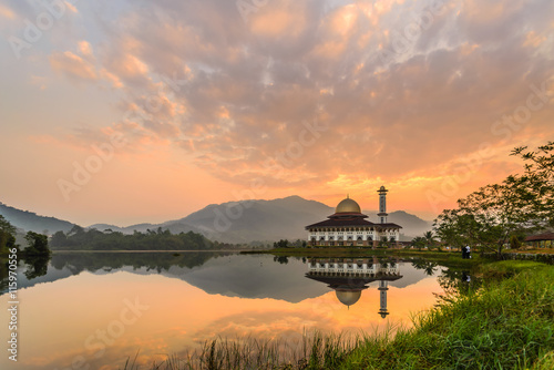 Beautiful Calm Morning At Darul Quran Mosque with perfect reflection on lake surface.