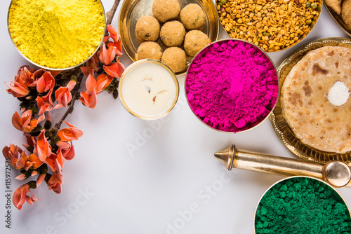 holi festival food with colours, indian festival holi, samosa, kachori, laddu, gujiya, palash flower, thandai, farsan, puran poli or roti, indian festival of colours called holi
