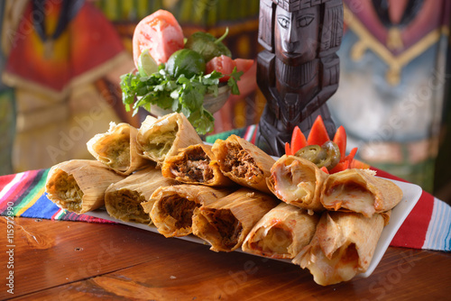 Traditional Mexican food tamales platter with garnishes