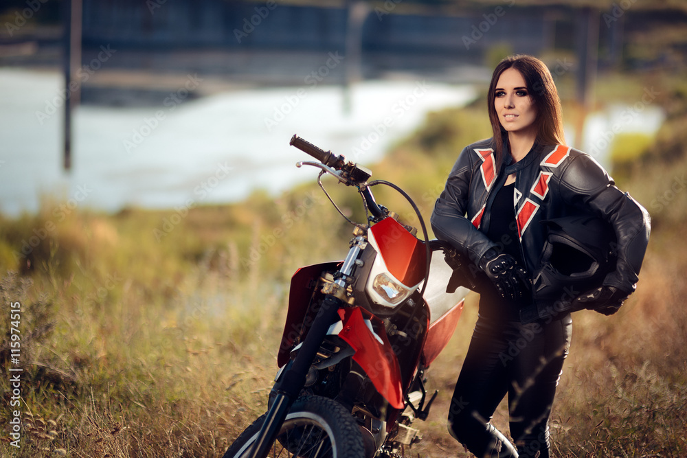 Fototapeta premium Female Motocross Racer Next to Her Motorcycle 