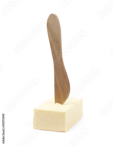 Knife over a piece of butter isolated photo