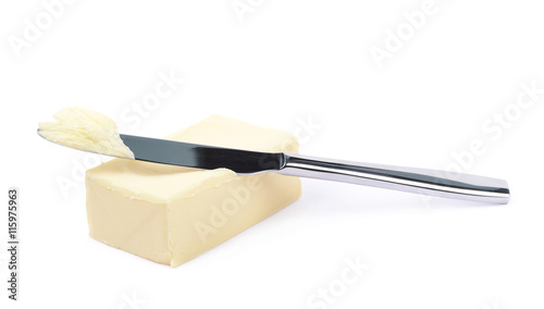 Knife over a piece of butter isolated photo