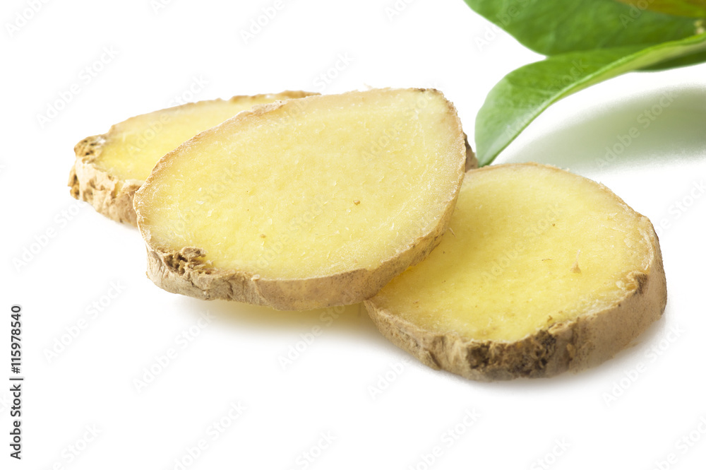 Fresh sliced ginger root and leaves on the white Fresh sliced ginger root and leaves on the white
