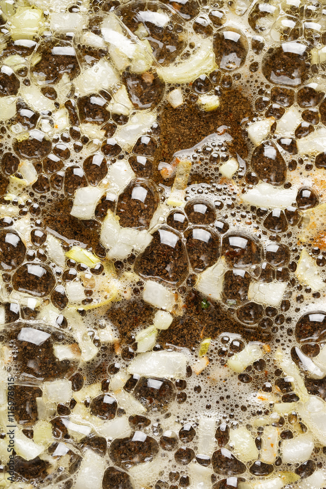 Onions fried in butter, close up, top view Onions fried in butter, close up, top view