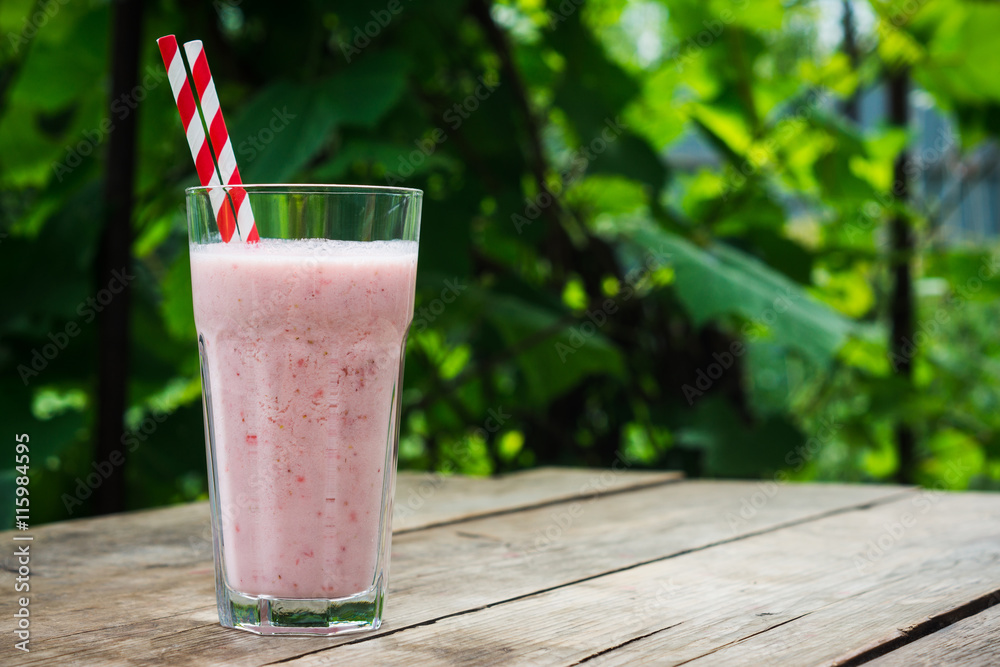 Strawberry milkshake on the rustic wooden background Strawberry milkshake on the rustic wooden background