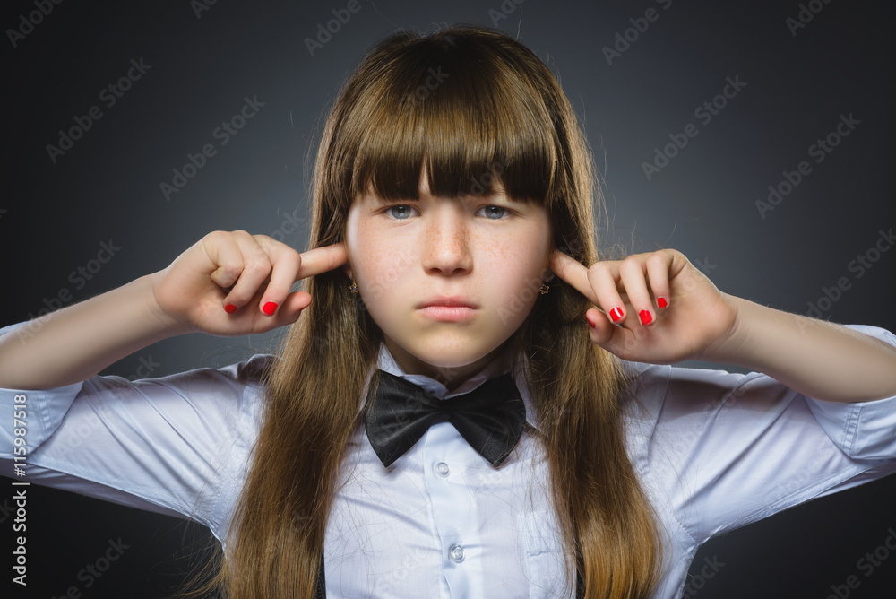 Fototapeta premium Closeup portrait of worried girl covering her ears, observing. Hear nothing. Human emotions, facial expressions