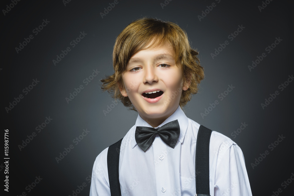 doubt, expression and people concept - boy thinking over gray background doubt, expression and people concept - boy thinking over gray background