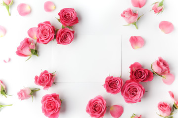 Framework from roses on white background. Flat lay. Top view