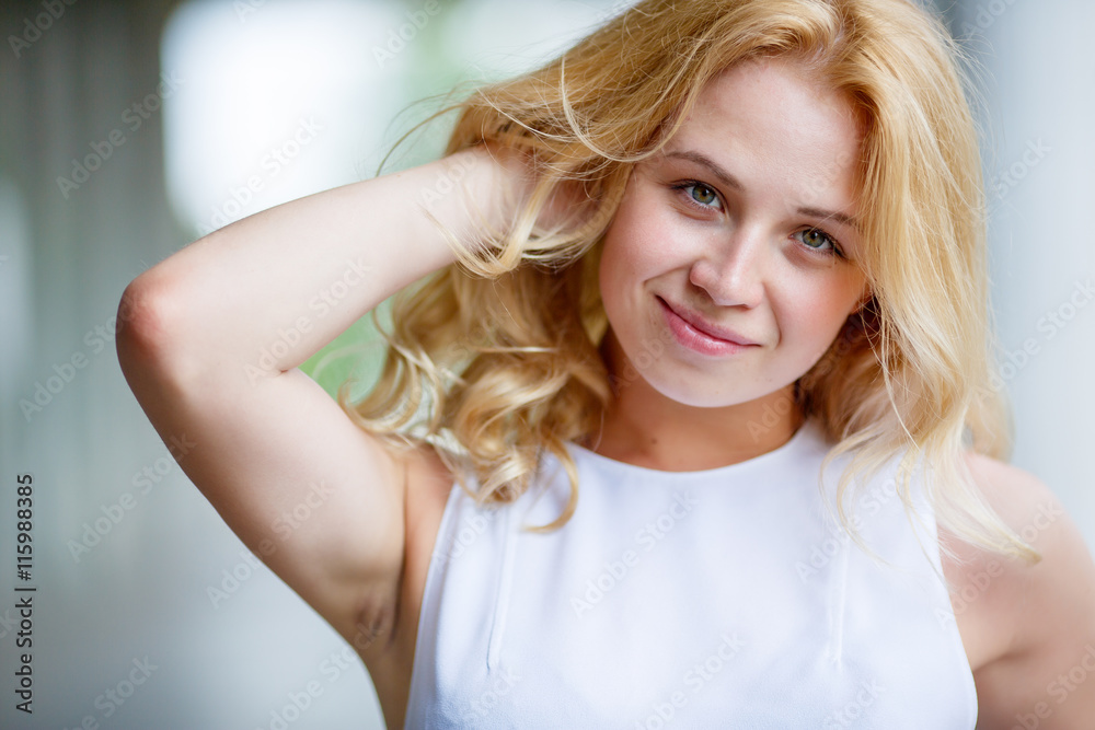 Young slavic woman touches her blonde hair Young slavic woman touches her blonde hair