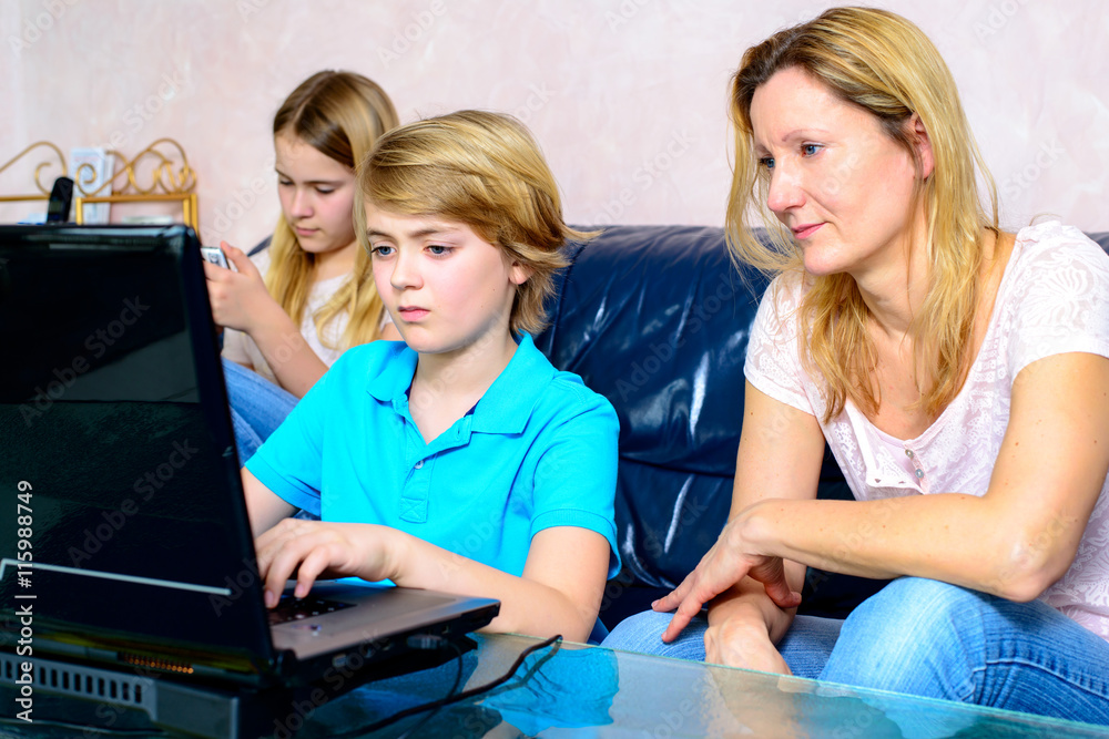 mother and her children using computer mother and her children using computer