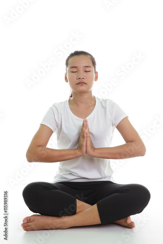 Portrait of young woman meditating in pose