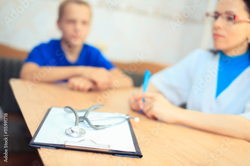 Attractive female doctor shaking a patient's hands in her office