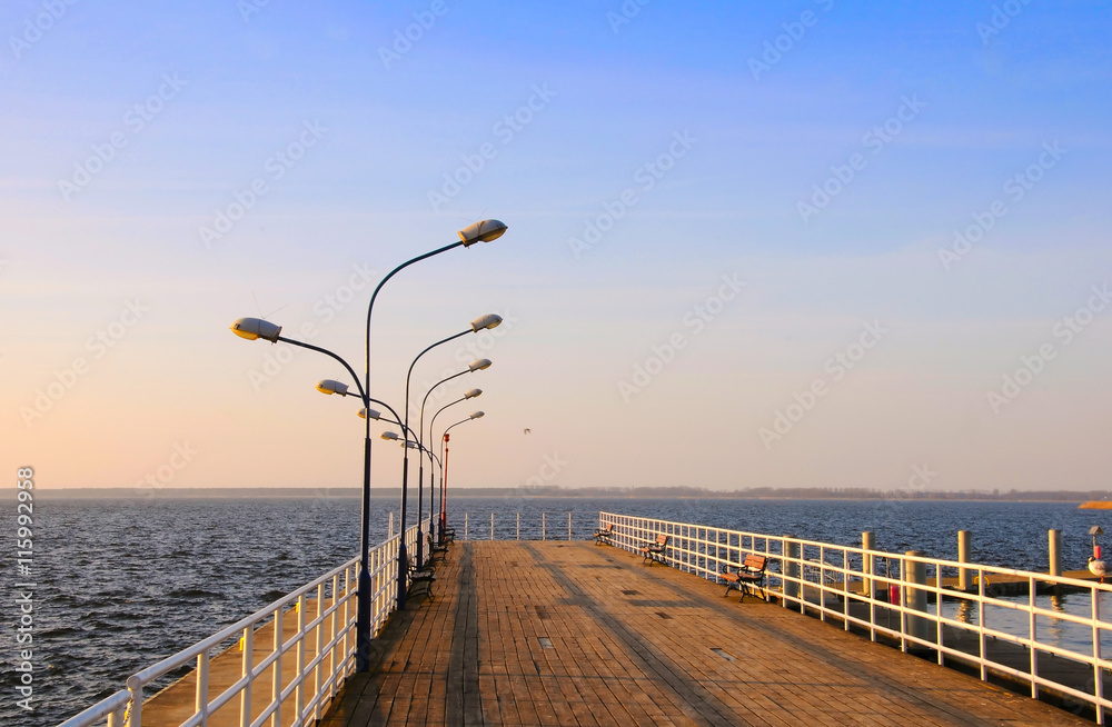 Wooden pier and lanterns on sunny summer day