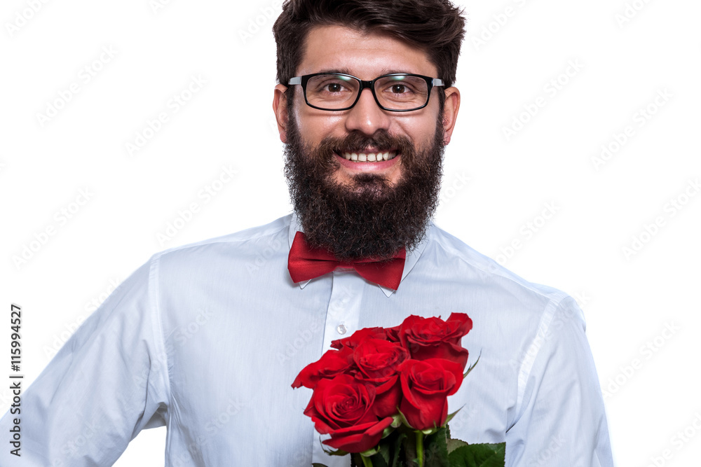 Charmingly chivalrous. Smiling young man in eyewear holding a bunch of roses and looking at camera while standing against white background. Charmingly chivalrous. Smiling young man in eyewear holding a bunch of roses and looking at camera while standing against white background.