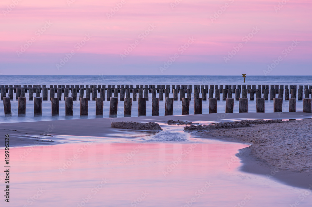 Wooden breakwaters - Baltic seascape at sunset, Poland