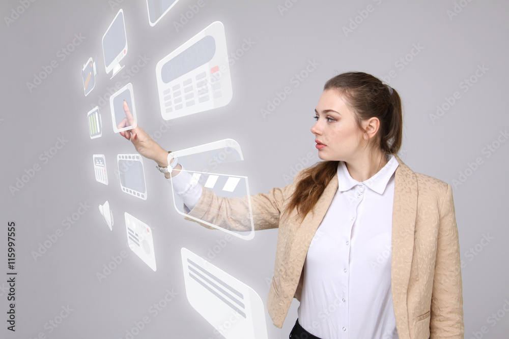 Woman pressing multimedia and entertainment icons on a virtual background Woman pressing multimedia and entertainment icons on a virtual background