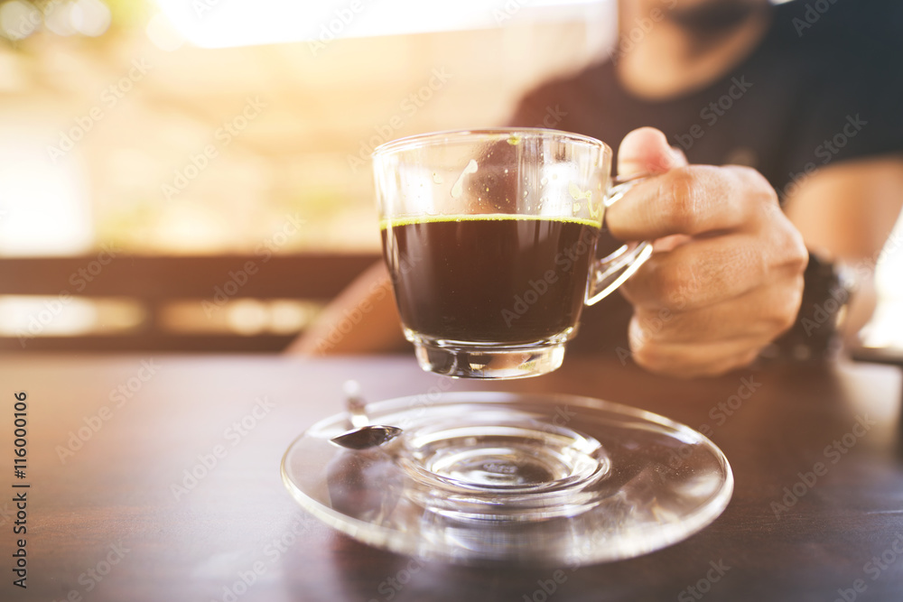 Fototapeta premium hands holding cups of coffee on rustic wooden table background