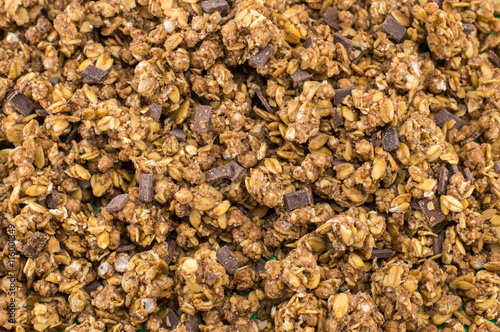 Healthy granola muesli cereals with chocolate background