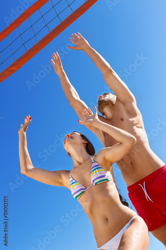 Beautiful  young couple  playing volleyball