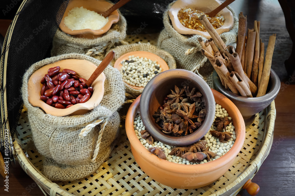 Spices herbs and seed beans in sacks and clay mortar, Local herbs in Thailand. Spices herbs and seed beans in sacks and clay mortar, Local herbs in Thailand.