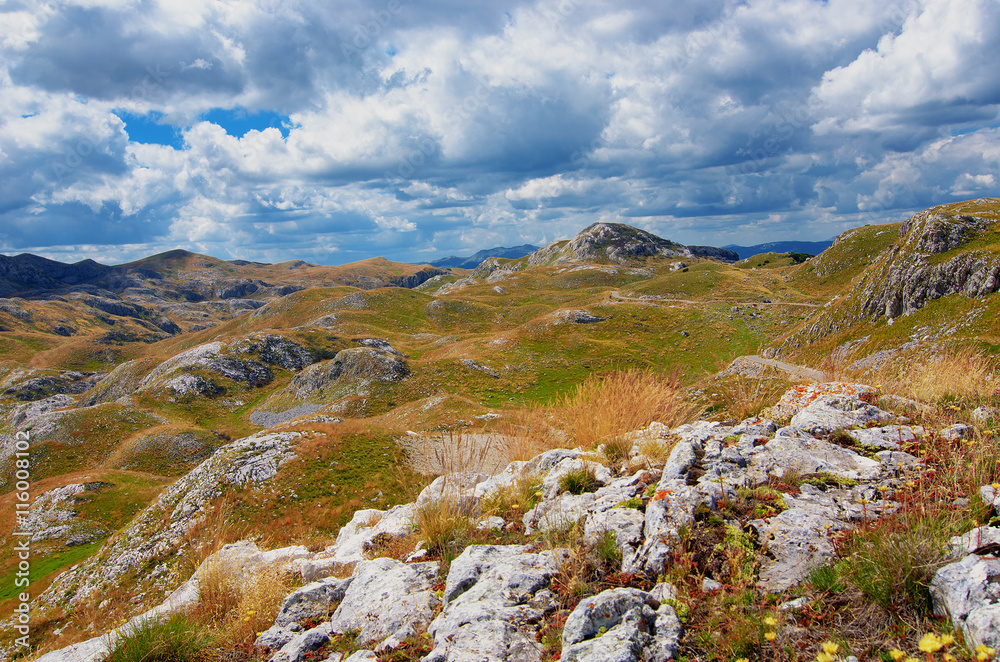 Montenegro, national park Durmitor, mountains and clouds panorama. Sunlight lanscape. Nature travel background.