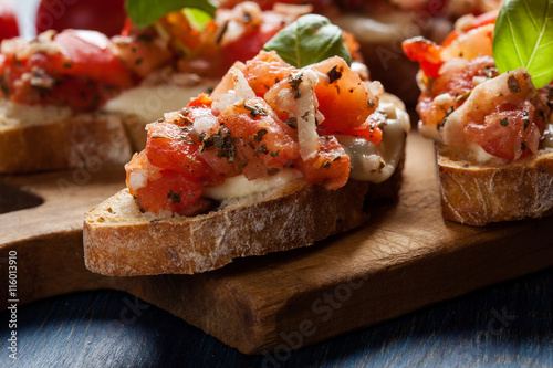Italian bruschetta with roasted tomatoes, mozzarella cheese and