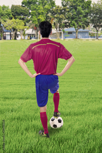 Soccer player with ball at the field