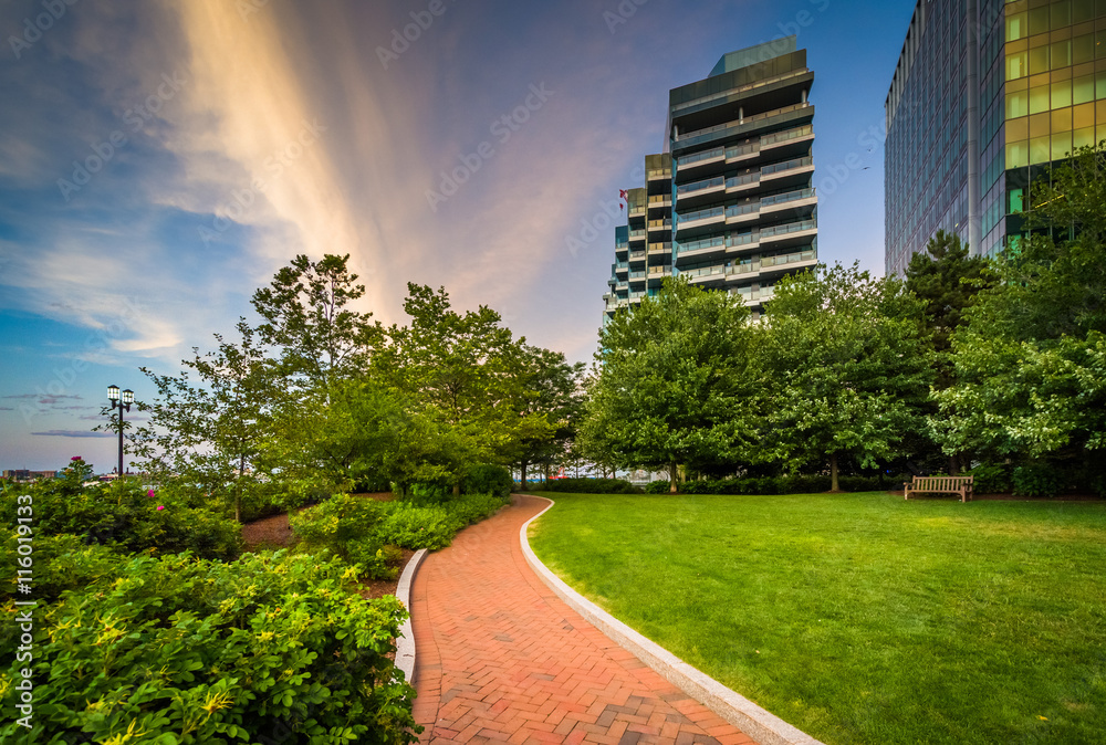 Modern skyscrapers and walkways at Fan Pier Park at sunset, in B