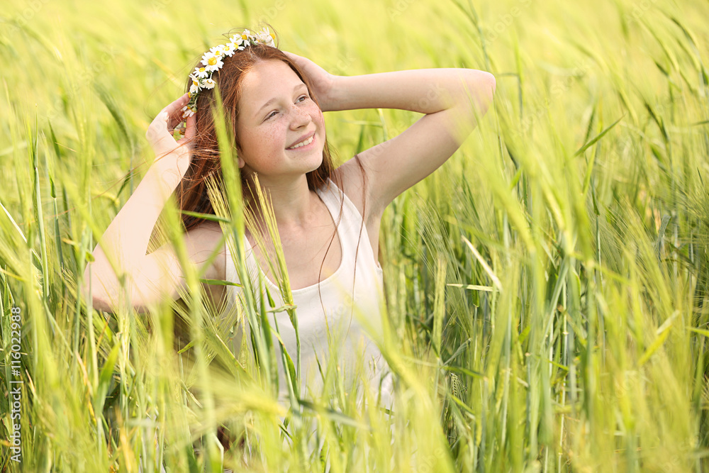 Sweet girl in meadow with wild spring flowers Sweet girl in meadow with wild spring flowers