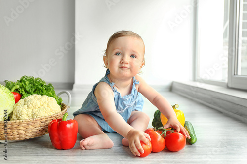 Cute baby girl with vegetab...