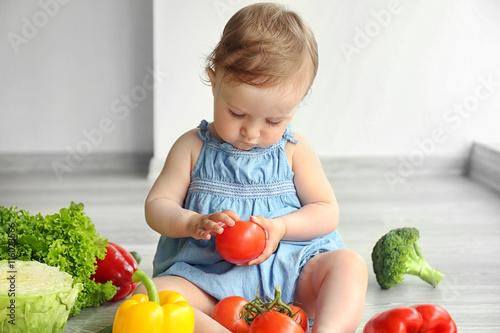 Cute baby girl with vegetab...