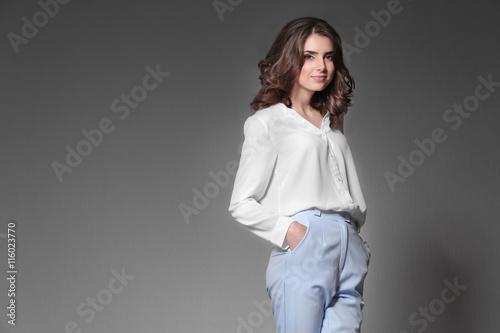 Pretty woman on grey backgr...