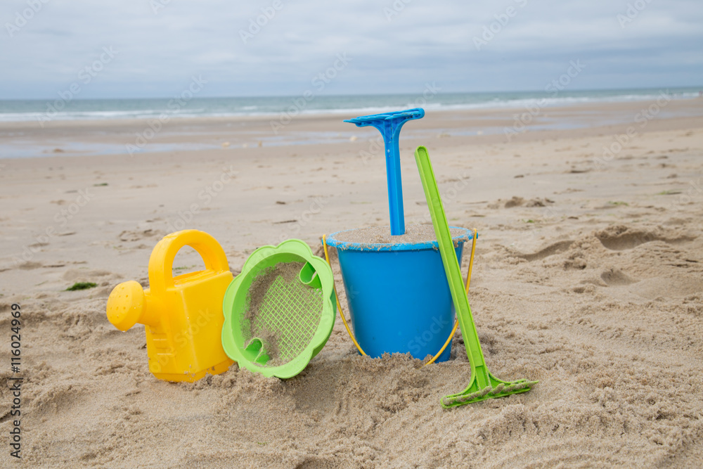 Child's toys on sandy beach, summer holidays concept Child's toys on sandy beach, summer holidays concept