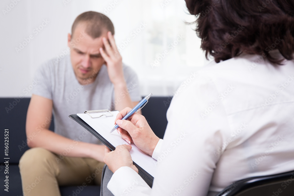 young sad man patient and female doctor