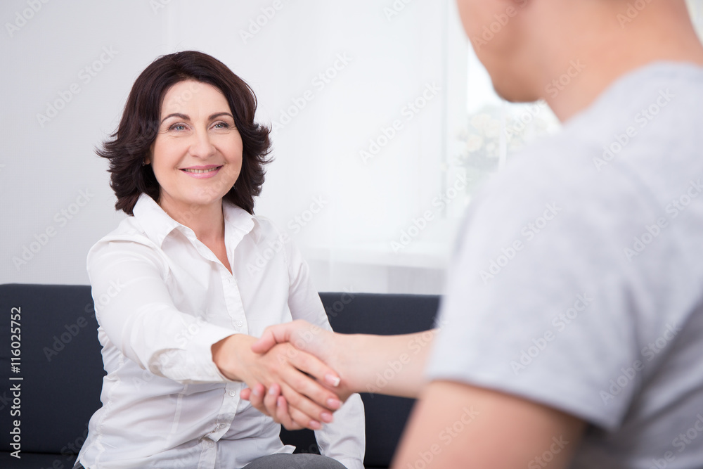businessman and businesswoman shaking hands in office businessman and businesswoman shaking hands in office