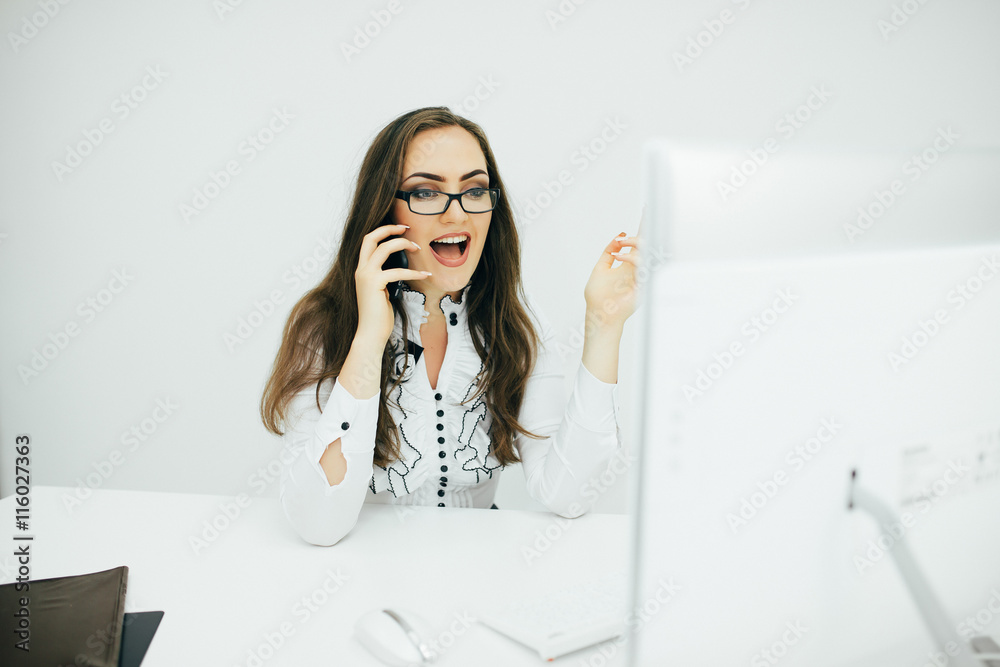 Young pretty business woman talk on phone in the office Young pretty business woman talk on phone in the office