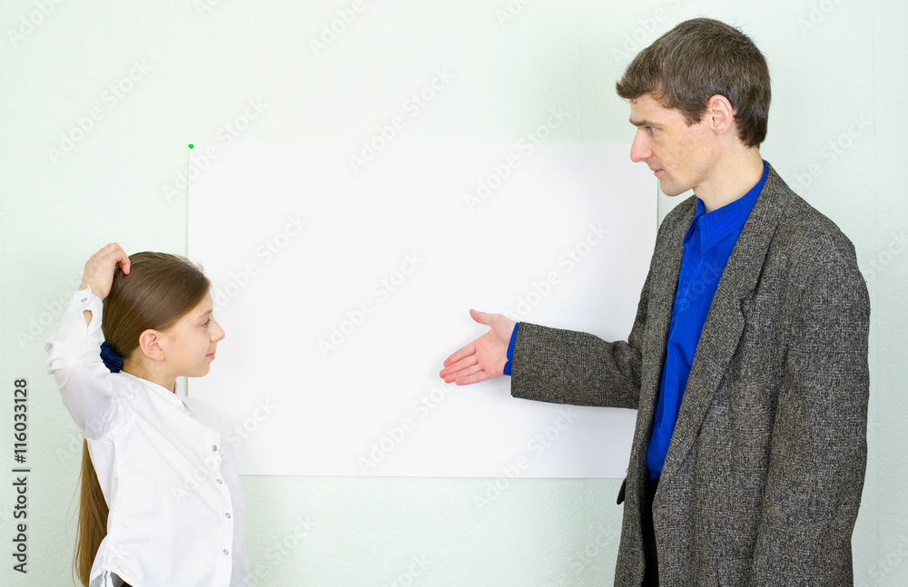 Teacher explains something to the schoolgirl