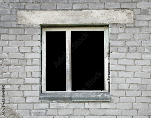 Dark window of the thrown old building