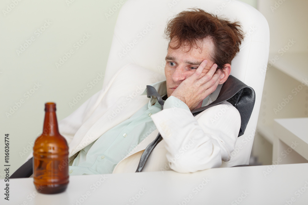 Fototapeta premium Young drunkard with hangover after holiday