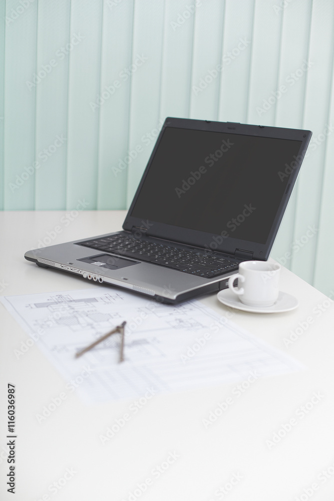 Laptop on table with drawing and a compasses - business still-li Laptop on table with drawing and a compasses - business still-li