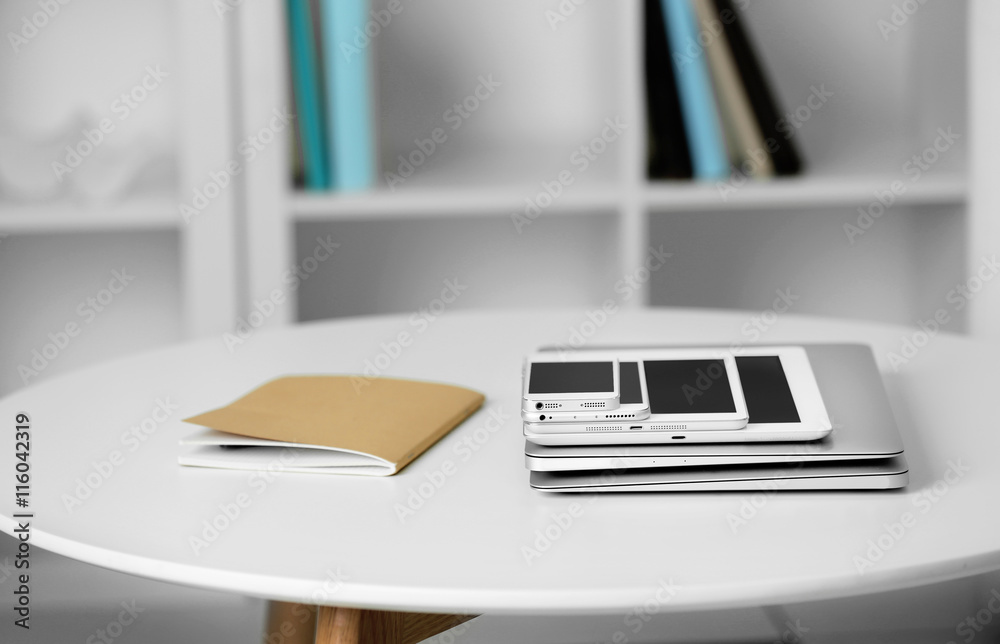 Pile of electronic gadgets on the table. Communication and technology concept Pile of electronic gadgets on the table. Communication and technology concept
