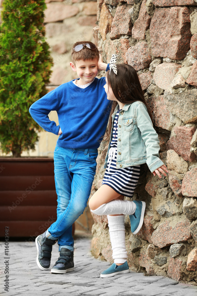 Little kids wearing stylish clothes outdoors. Fashion kid concept